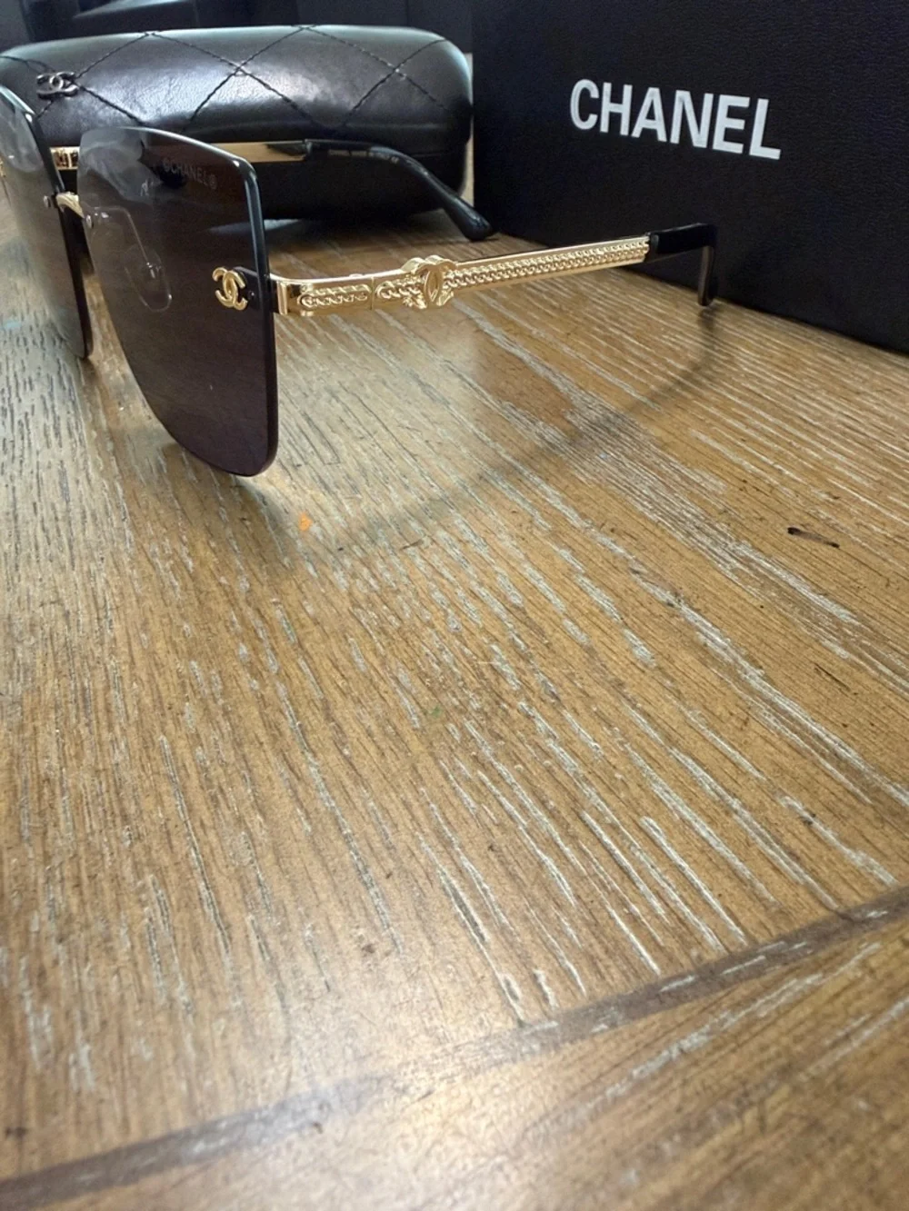 Chanel Women's Black and Gold Rimless Square Sunglasses
